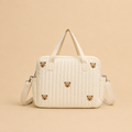 Sac à langer beige motif ourson avec une poche avant brodée en vue de dos